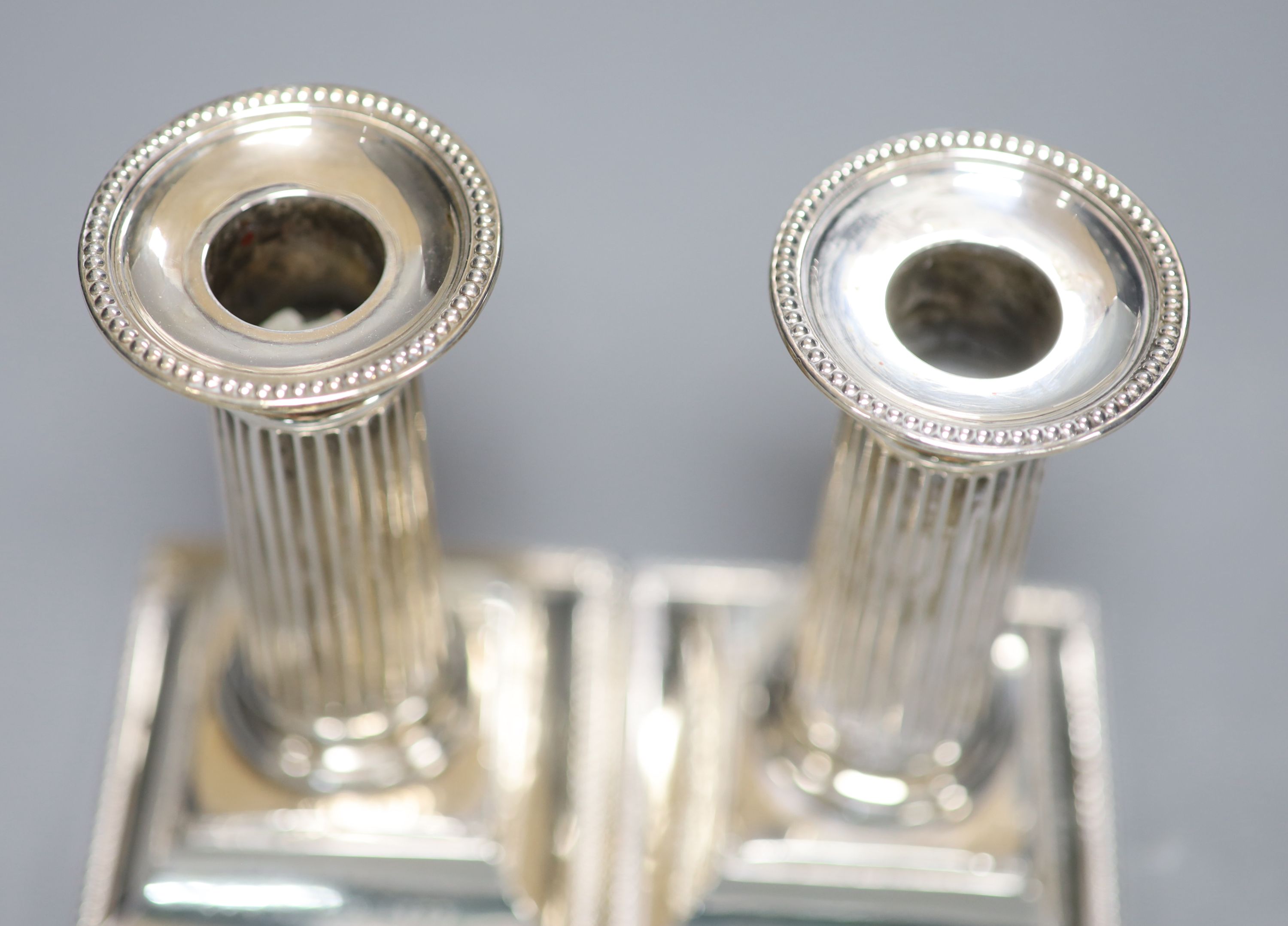 A pair of late Victorian silver dwarf candlesticks, with engraved inscriptions, Martin, Hall & Co, Sheffield, 1882, 12.9cm